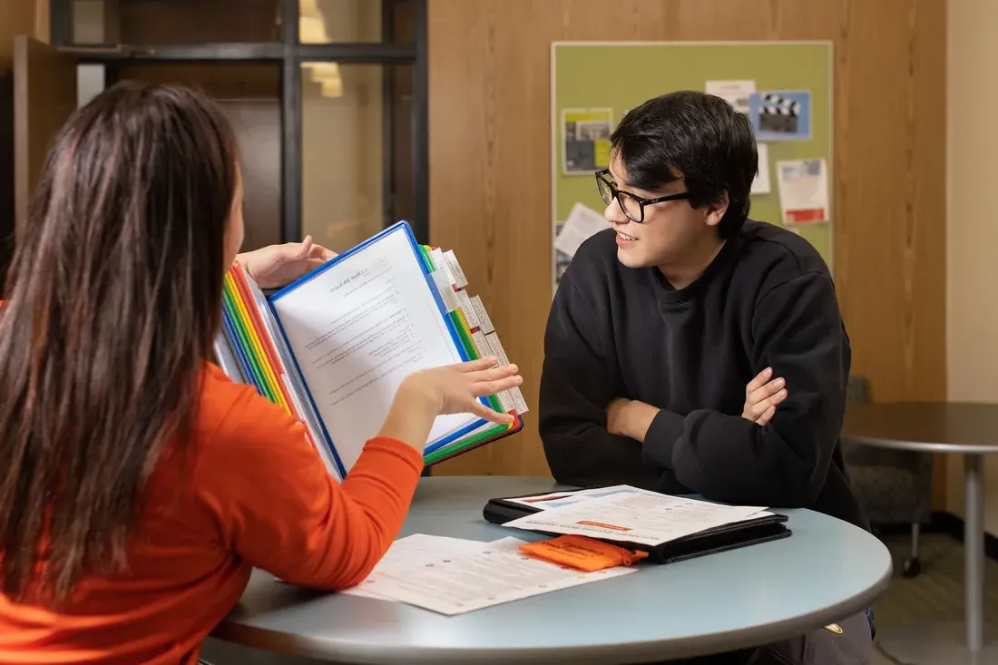 Students working together around a table.